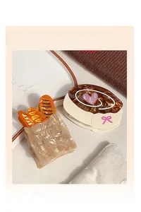 Detail of creative baguette and cinnamon roll acetate hair claws with Baking Lover text