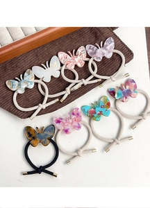 Détails d'élastiques papillon en acétate coloré avec motifs marbrés et attaches élastiques