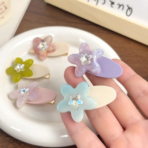 Star-shaped acetate hair clips with rhinestones in five assorted Morandi colors