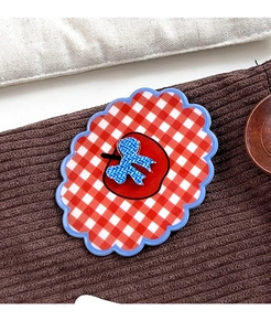 Close-up of vintage red plaid cloud-shaped hair claw with apple and bow pattern
