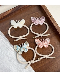 Détail de 4 chouchous papillon en acétate avec cordes tissées crème haute élasticité