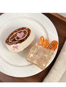 Detail of bakery themed acetate hair clips including coffee cup and baguette bag designs