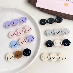 Set of colorful cartoon puppy hair clips with cute poodle designs on acetate duckbill clips