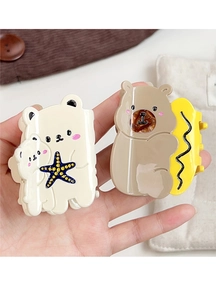 Close-up of cute bear claw clips in cream and khaki with acetate glossy finish