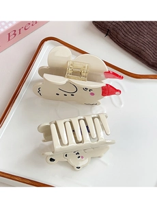 Close-up of cute cream-colored bear hair claws with matte finish and golden springs
