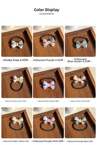 Detail view of acetate bow hair ties in nine colors on a wooden tray with size markings