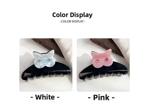 Détail des pinces à cheveux hibou en blanc et rose avec des yeux en strass brillants