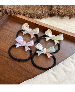 Set of four acetic acid bow hair ties with France Handmade logo on a wooden tray