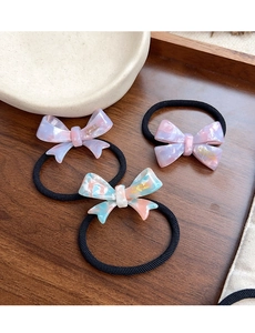 Detailed macro of marble texture acetate bow hair ties with France Handmade gold lettering