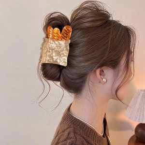 Creative baguette bread hair claw clip with baking text design for elegant hairstyling
