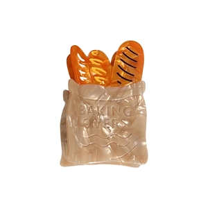 Bread bag shaped acetate hair claw clip with baking lovers text on white background