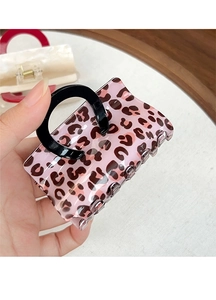 Detail of pink leopard print handbag-shaped hair claw clip with black top handle design