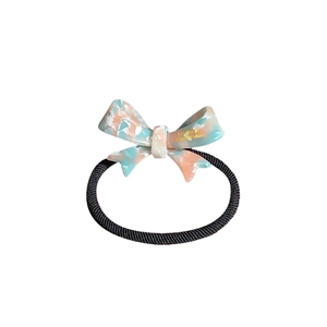 Acetate bow hair tie with marble texture and gold lettering on high elastic band