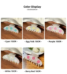 Detail showing five 10cm floral hair claws in cyan egg yellow purple white and berry red