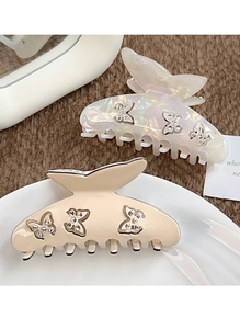 Vue détaillée de pinces à cheveux papillon en acétate avec strass brillants et perles