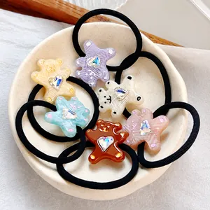Close-up of cute cartoon bear hair ties with heart rhinestones in six pastel colors