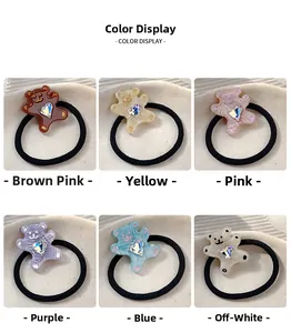 Detail display of six colorful resin bear hair ties with heart crystal decorations