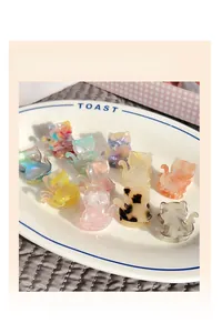 Detailed close-up of colorful acetate cat hair claws in various marble patterns