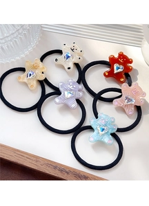 Set of six colorful bear hair ties with heart rhinestones on a white surface