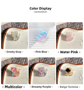 Detail view of cat-shaped acetate hair claws in six different colors and marble patterns