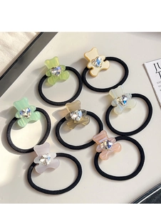 Detail of seven-piece elastic hair ties with colorful resin bear charms and heart crystals