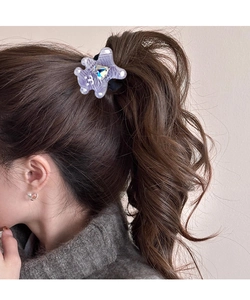 Detail of cute purple bear hair tie with polka dots and heart crystal on a ponytail