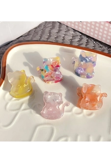 Close-up of five mini cat hair claws in acetate with colorful marble patterns