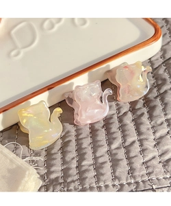 Detailed view of three cute cat-shaped acetate hair clips with pearl iridescent finish