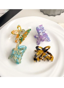 Detailed set of four acetate butterfly hair claws with colorful marble and tortoiseshell patterns