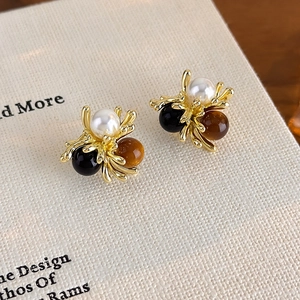 Vintage gold stud earrings with faux pearl, black and tiger eye beads in a floral cluster