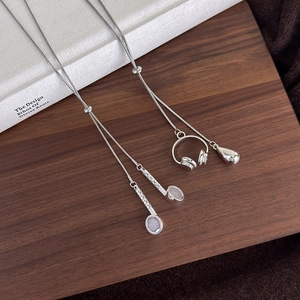 Close-up of adjustable silver snake chain necklace with headphone and droplet pendant