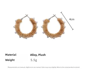 Détail de boucles d'oreilles créoles marron en peluche de 4 cm avec perles blanches
