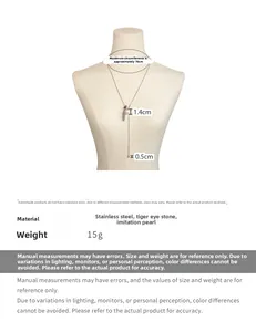 Detail view of Y-shaped necklace with tiger eye beads, faux pearl and metal tassel accents