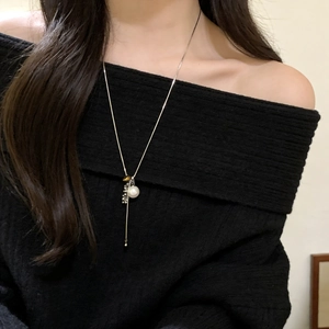Elegant beaded tiger eye pearl tassel necklace for women over black sweater