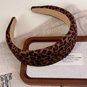 Detailed macro view showing the plush leopard print fabric and beige non-slip lining
