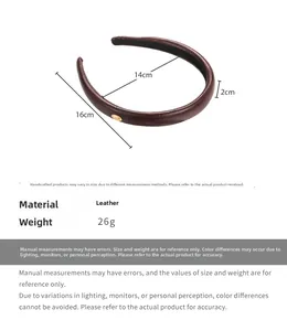 Macro shot of dark brown faux leather headband with gold metal tag and non-slip inner grip