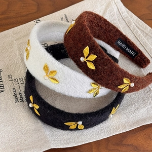 Retro wool hairbands in black, white, and brown with gold leaf and pearl accents