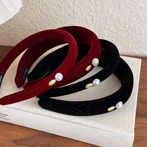 Vintage velvet headbands in burgundy and black with pearls on a rustic wood background