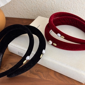 Detail of red and black velvet headbands with pearl accents and handmade woven label