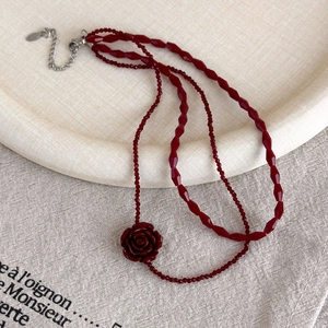 Detailed macro view of dark red beads and silver metal lobster clasp of the vintage necklace