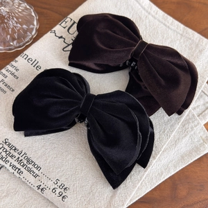 Velvet bow banana hair clips set in black and dark brown on a vintage background