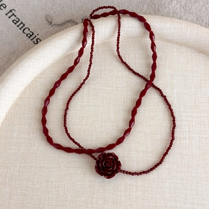 Detail of vintage red rose beaded double-layer choker with silver extender chain