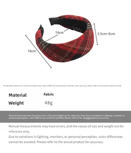 Close-up of red and black plaid fabric headband with thick padded vintage design