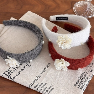 Detail of tweed headband with handmade camellia flower and pearls decoration