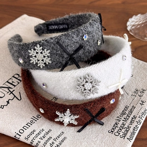 Close-up of winter rhinestone snowflake headbands with plush fabric and bow details