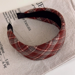 Detail view of wide plaid headband with red and grey retro British style fabric