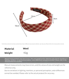 Macro detail of red plaid wide headband with size dimensions and handmade label