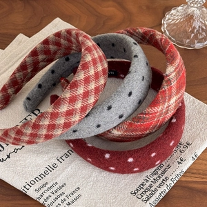 Detail of retro polka dot and plaid padded headbands in textured wool fabric