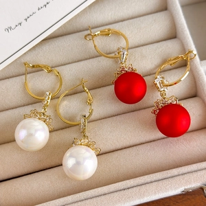 Elegant Chinese New Year pearl drop earrings with red and white beads in a jewelry box