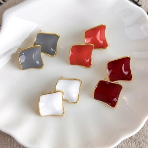 Minimalist geometric square stud earrings in burgundy and coral enamel set on shell tray